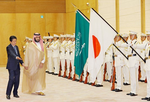Prince Muhammad accompanied by Japan’s Prime Minister Shinzo Abe reviews a guard of honor prior to their meeting in Tokyo, Thursday. — Reuters